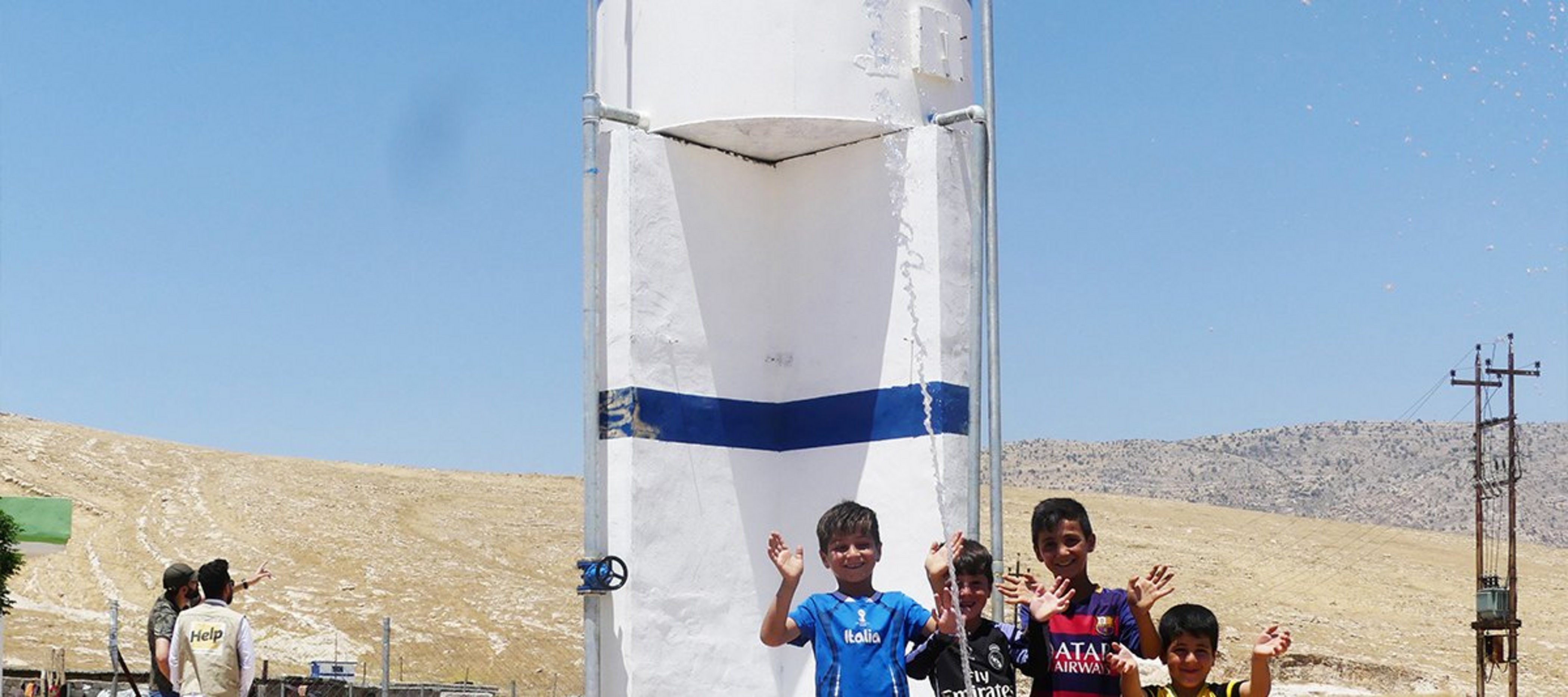 Kinder vor einem Wassertank im Irak