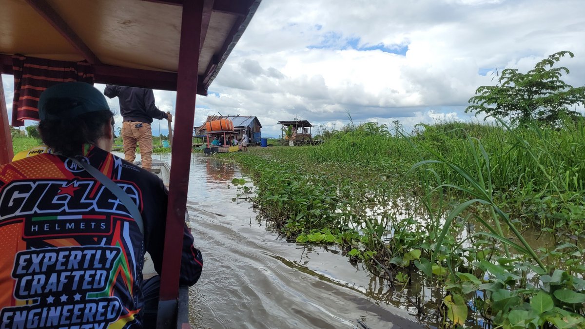 Residents travel through the marshland on a boat