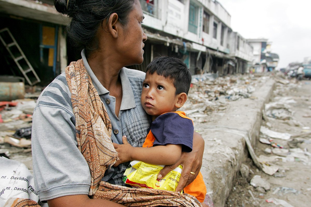 Indonesien: Mutter mit Kind in zerstörter Stadt