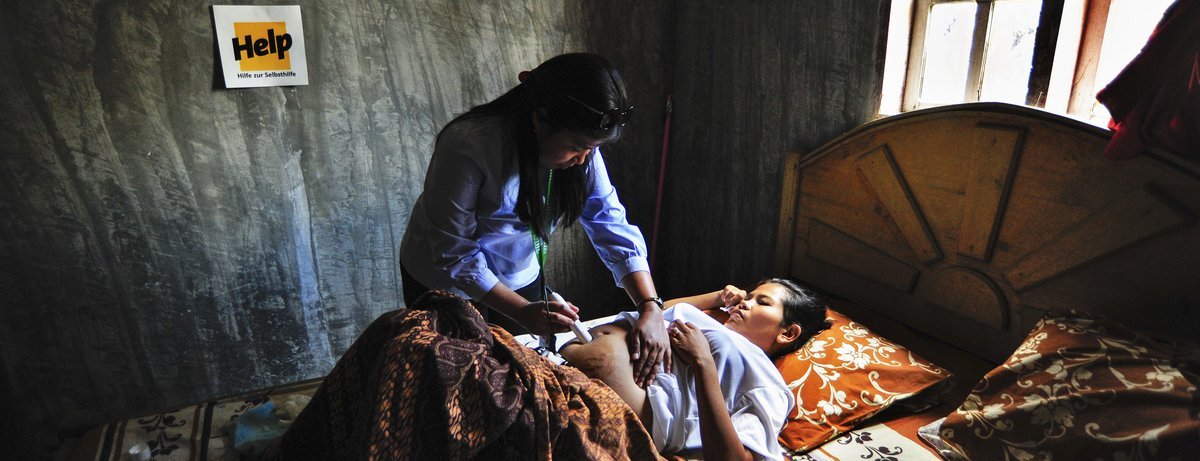 Eine Ärztin untersucht eine schwangere Frau in Indonesien