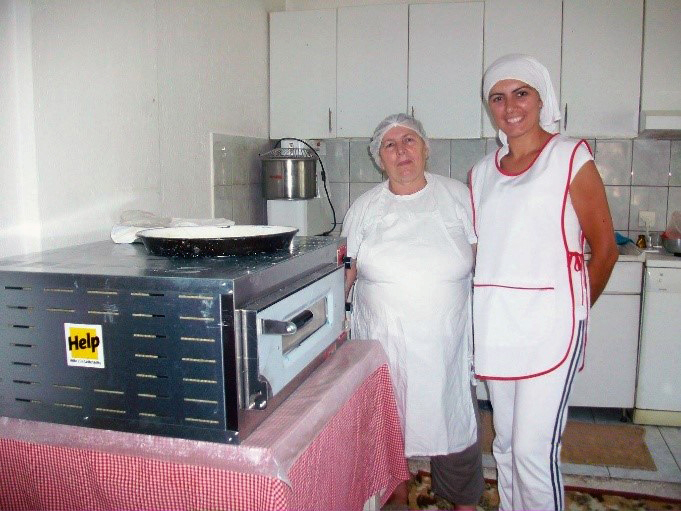 Hysnije und ihre Mitarbeiterin mit ihrem professionellen Ofen